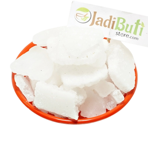 Bhimseni Kapoor white crystalline pieces on an orange plate — Jadibuti Store