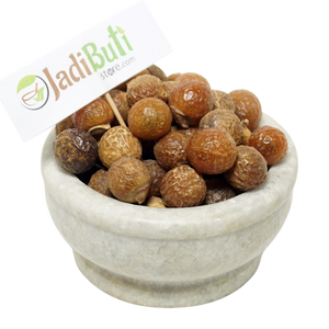 Dried Reetha soapnut fruits in a bowl with a Jadibuti Store card