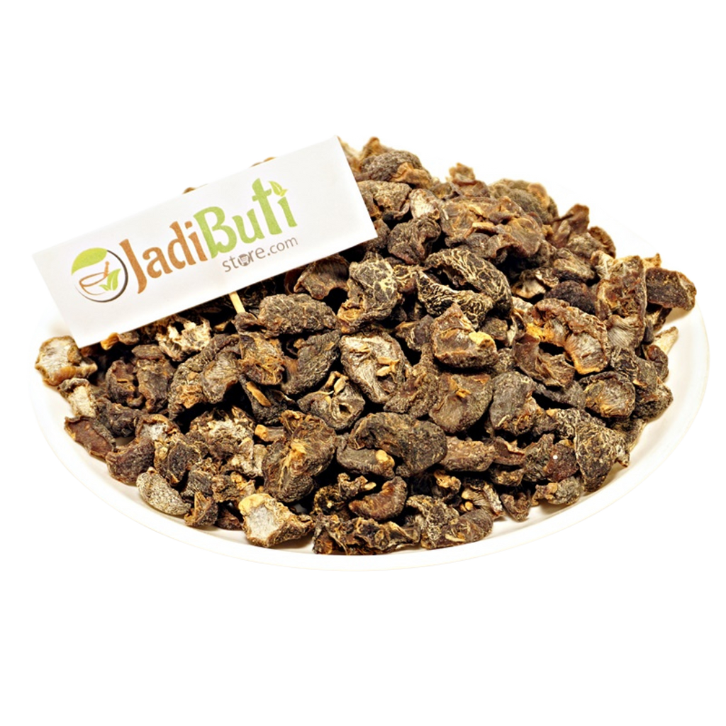 Dried Amla fruit pieces on a white plate with Jadibuti Store card