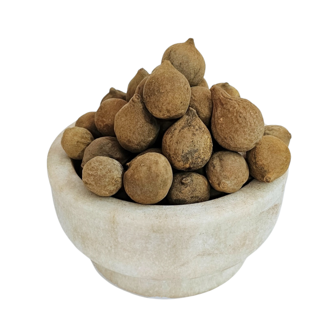 Baheda rounded brown dried whole fruits in a stone bowl — Jadibuti Store
