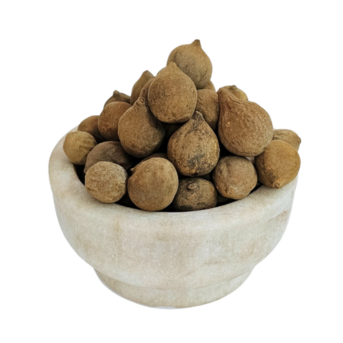 Baheda rounded brown dried whole fruits in a stone bowl — Jadibuti Store