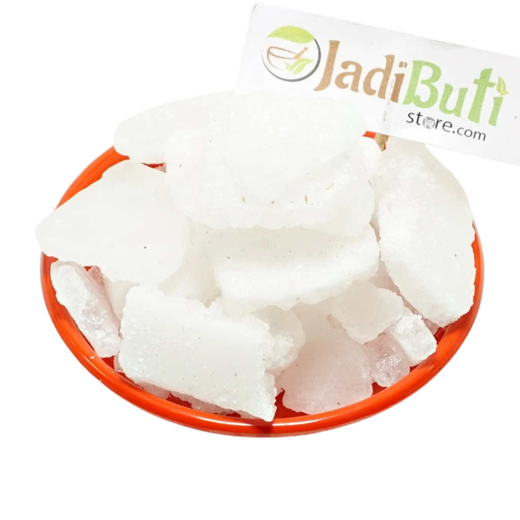 Bhimseni Kapoor white crystalline pieces on an orange plate — Jadibuti Store