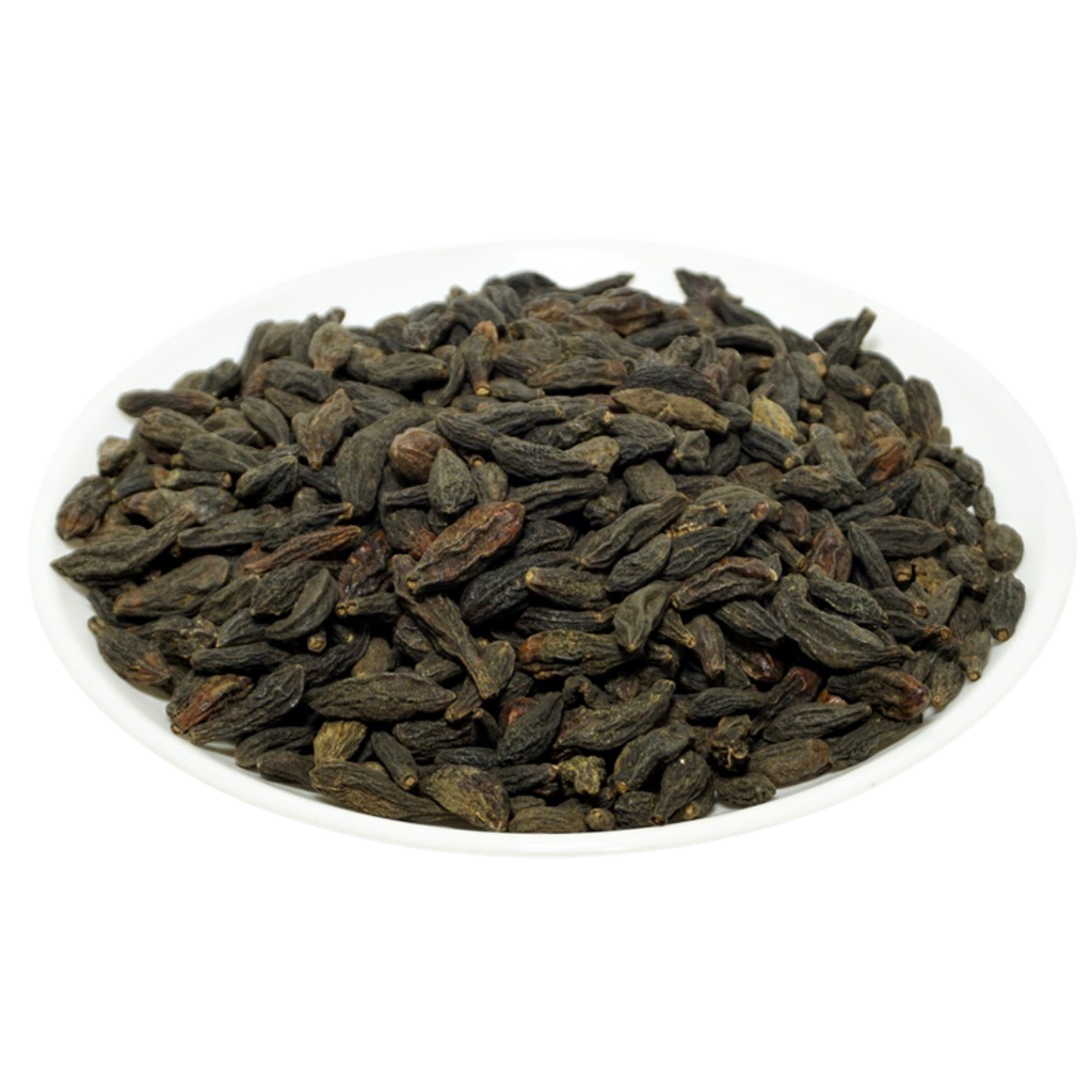 Natural Choti Harad Haritaki dark dried fruits on a white plate — Jadibuti Store