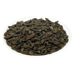 Natural Choti Harad Haritaki dark dried fruits on a white plate — Jadibuti Store