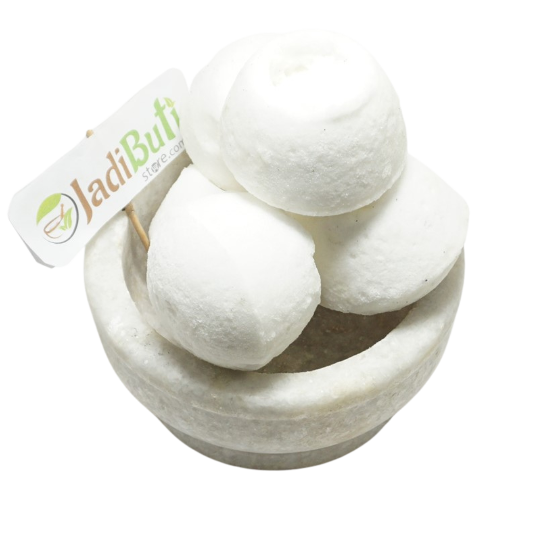 Kunja Mishri white rounded sugar-candy pieces with central indentations in a stone bowl — Jadibuti Store
