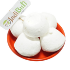 Kunja Mishri white rounded sugar-candy pieces in an orange bowl — Jadibuti Store