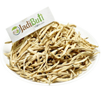 Natural dried Safed Musli root pieces on a white plate — Jadibuti Store