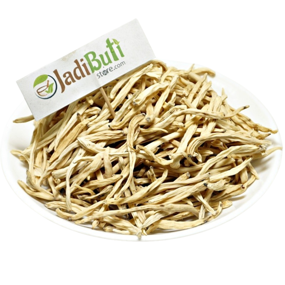 Natural dried Safed Musli root pieces on a white plate — Jadibuti Store