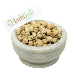 Paneer Doda pale tan rounded dried fruit pieces with papery material in a stone bowl — Jadibuti Store