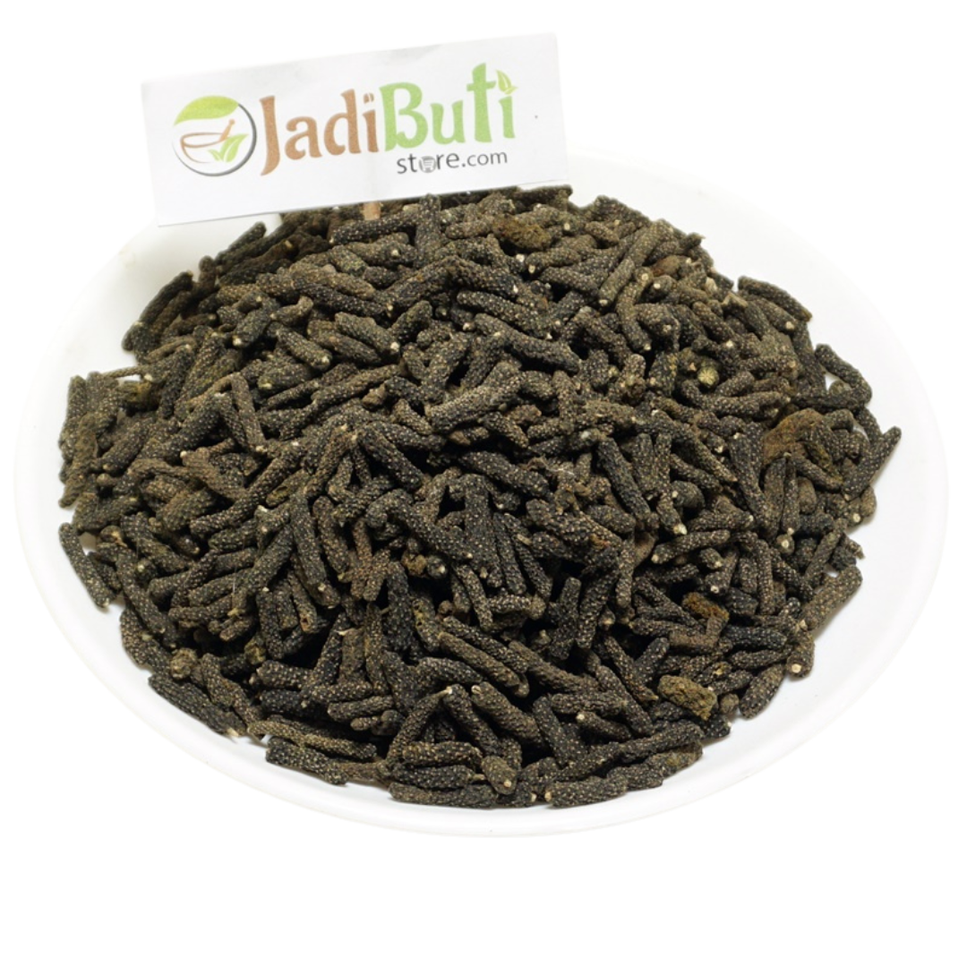 Pippali dried long-pepper fruiting spikes on a white plate — Jadibuti Store