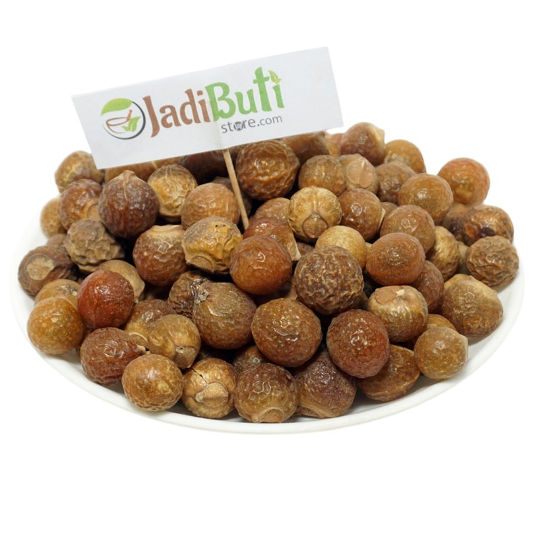 Dried Reetha soapnut fruits on a plate with a Jadibuti Store card