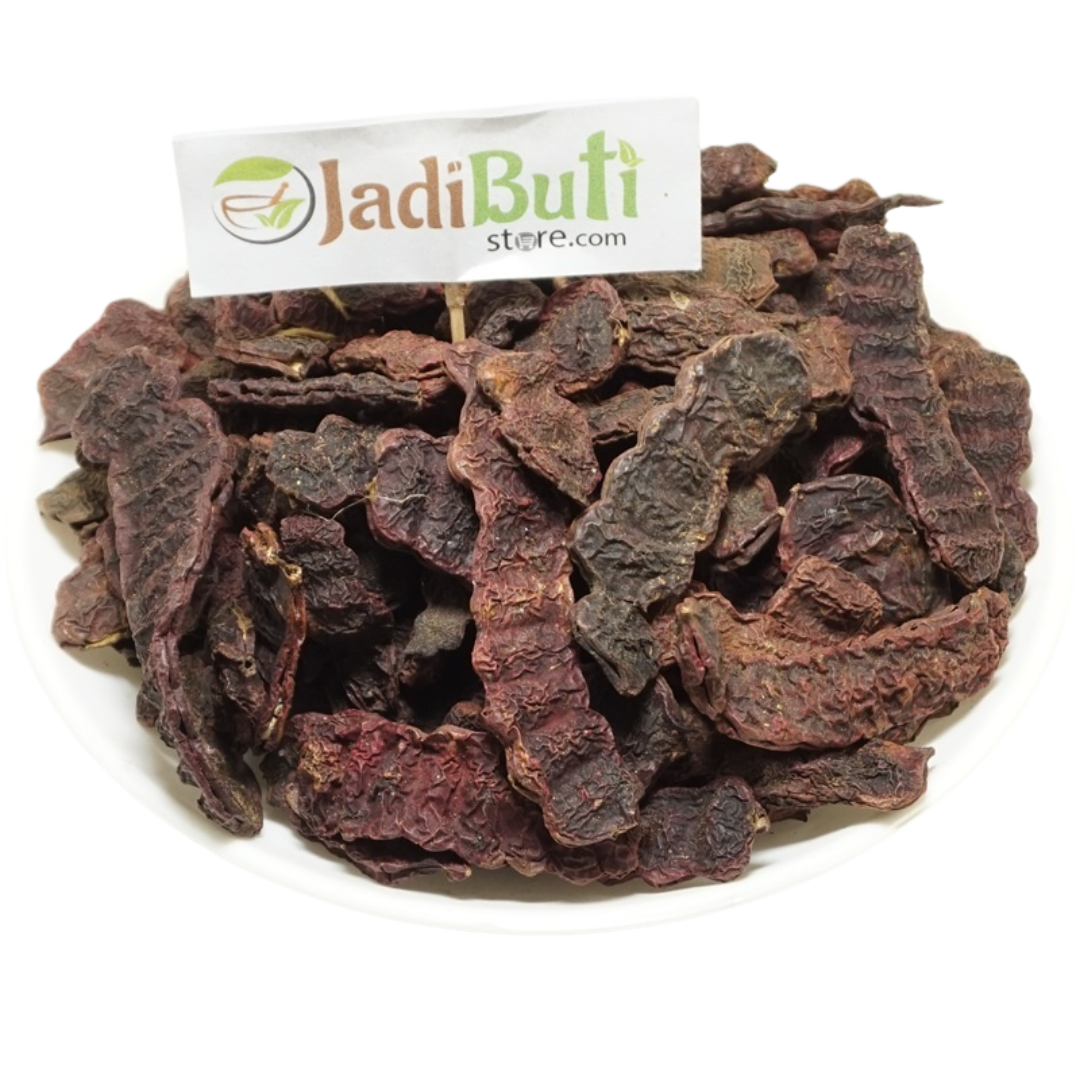 Dried Shikakai pods and pod pieces on a plate with a Jadibuti Store card