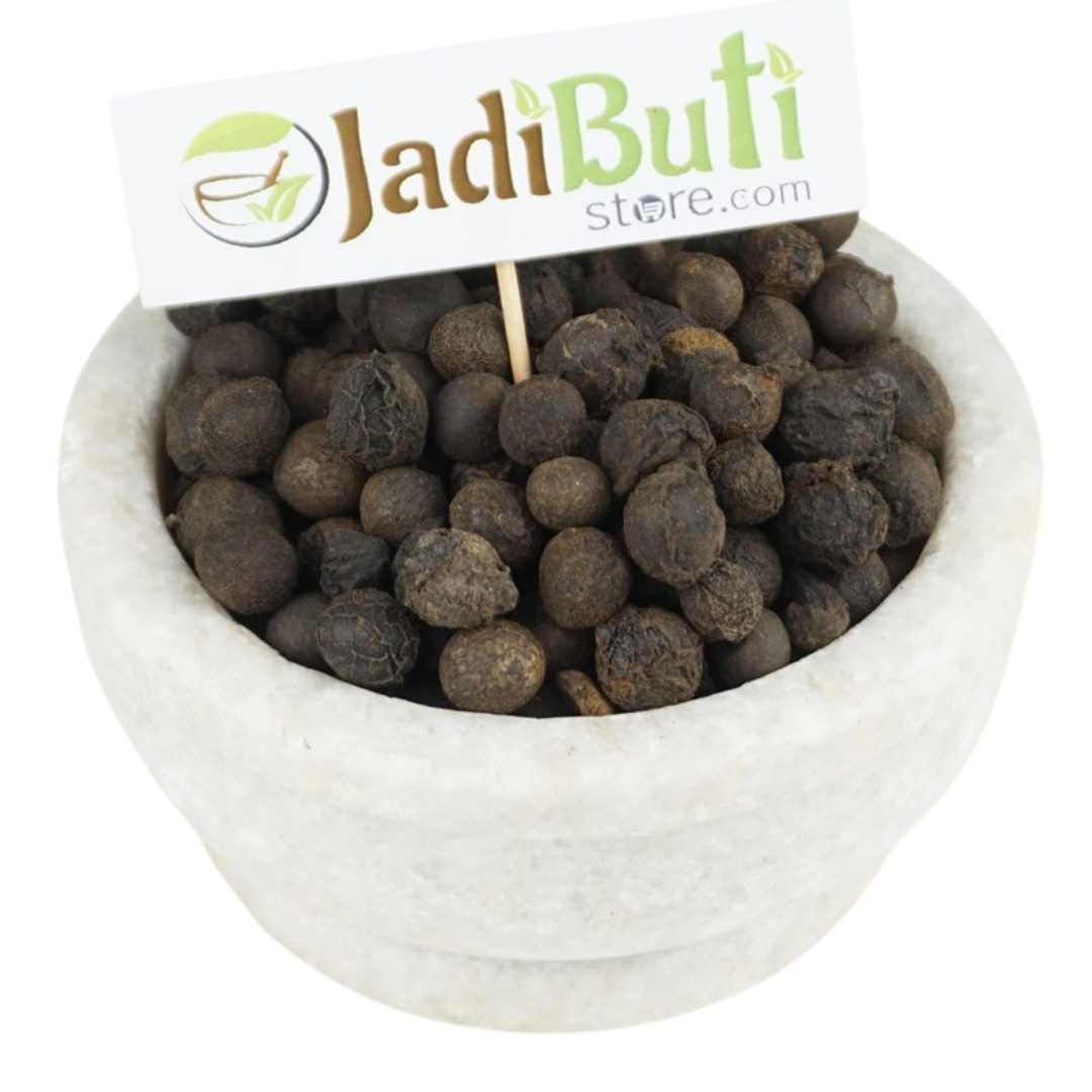 Sugandh Kokila dark rough rounded dried pieces in a stone bowl; species unverified — Jadibuti Store