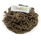 Tagar / Indian Valerian / तगर — dark brown rough underground pieces on a round plate