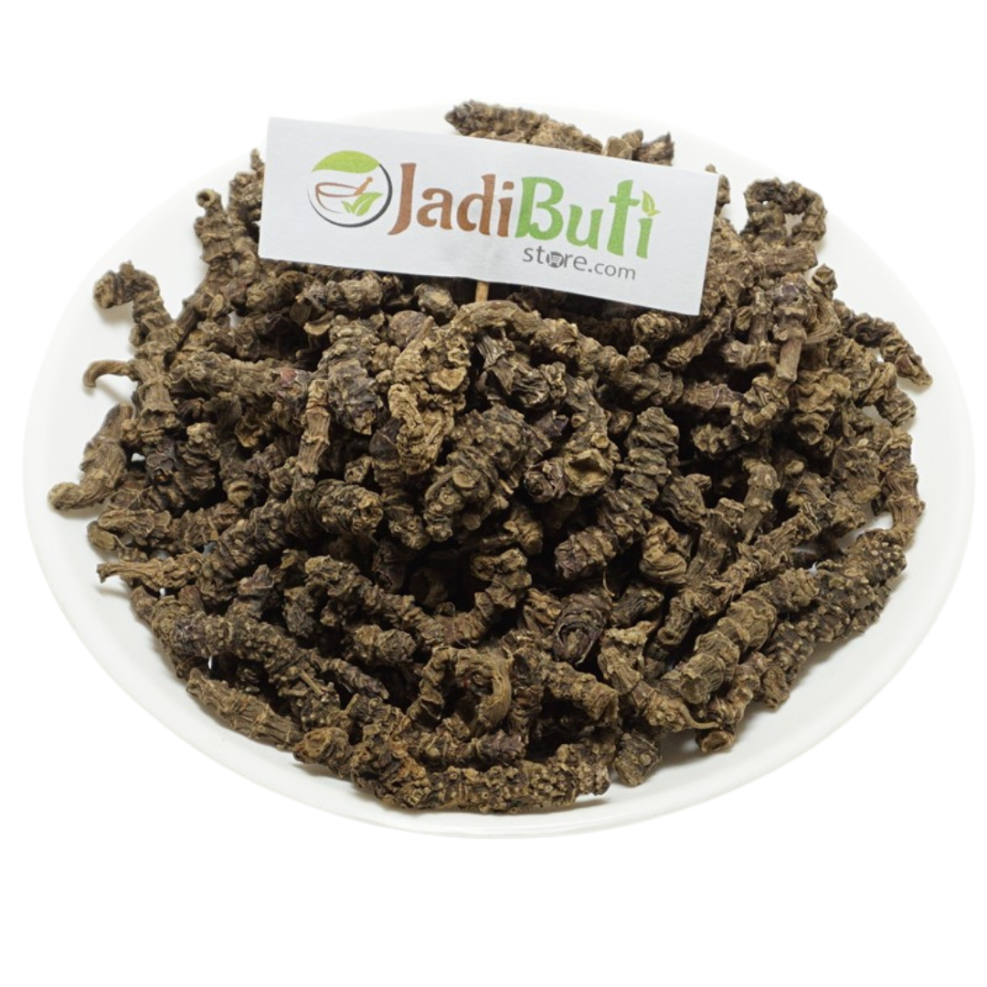 Tagar / Indian Valerian / तगर — dark brown rough underground pieces on a round plate