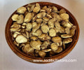 Kapoor Kachri tan-yellow cut underground material with darker edges in a wooden bowl; species pending — Jadibuti Store